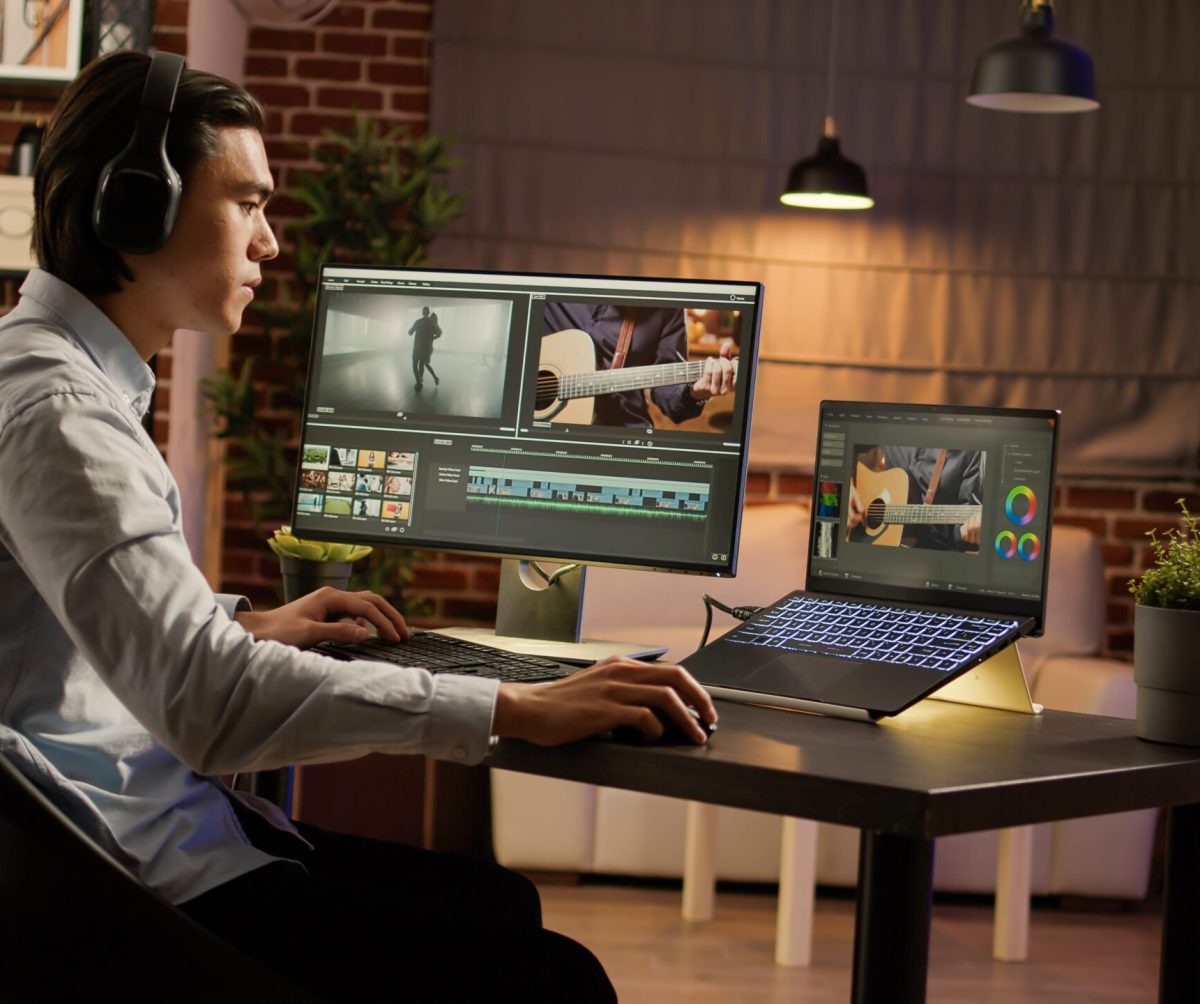 Asian man listening music editing video software using computer work film production creating videographer content with visual effects color gradient min