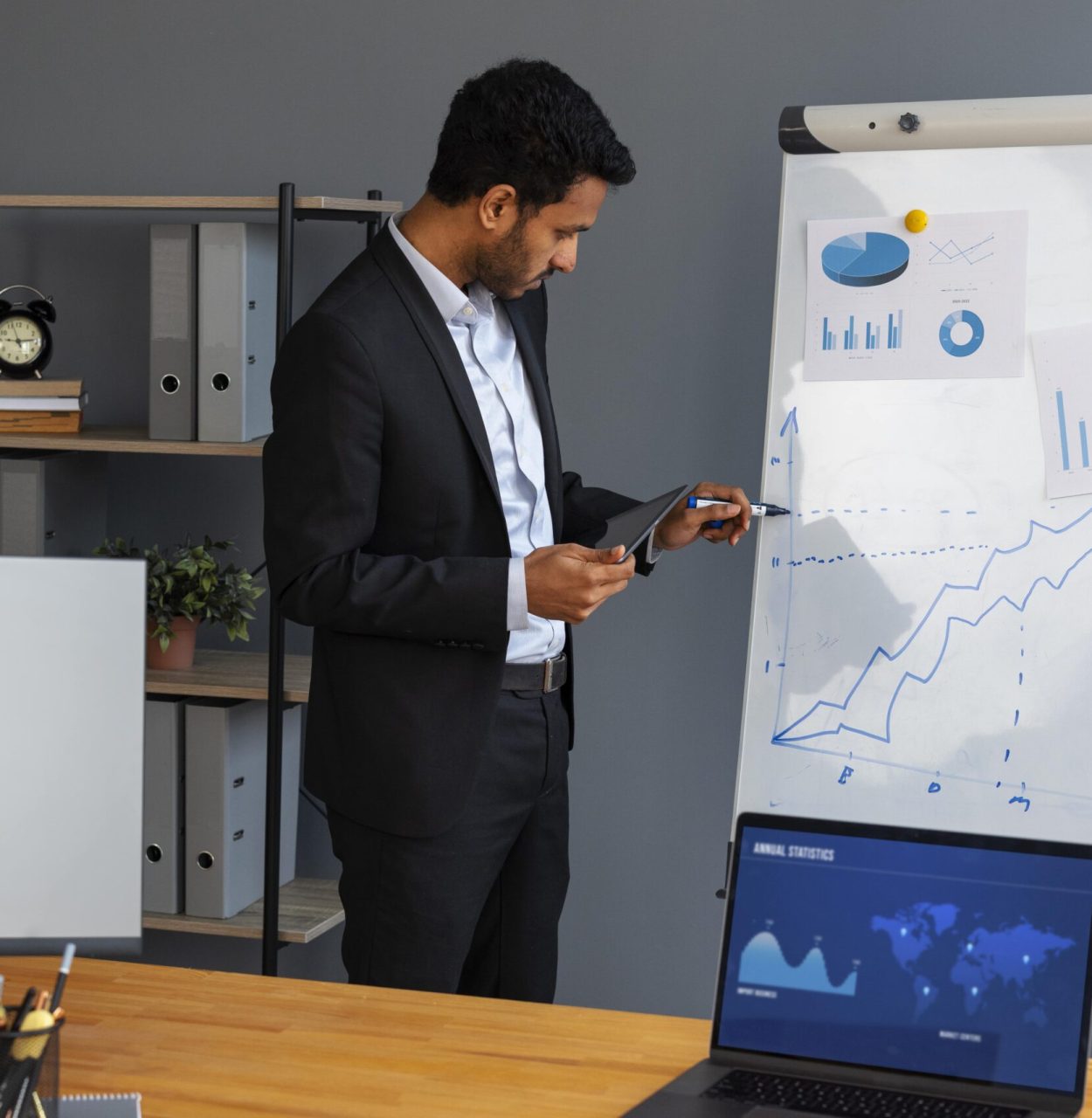 Business person looking finance graphs min (1)