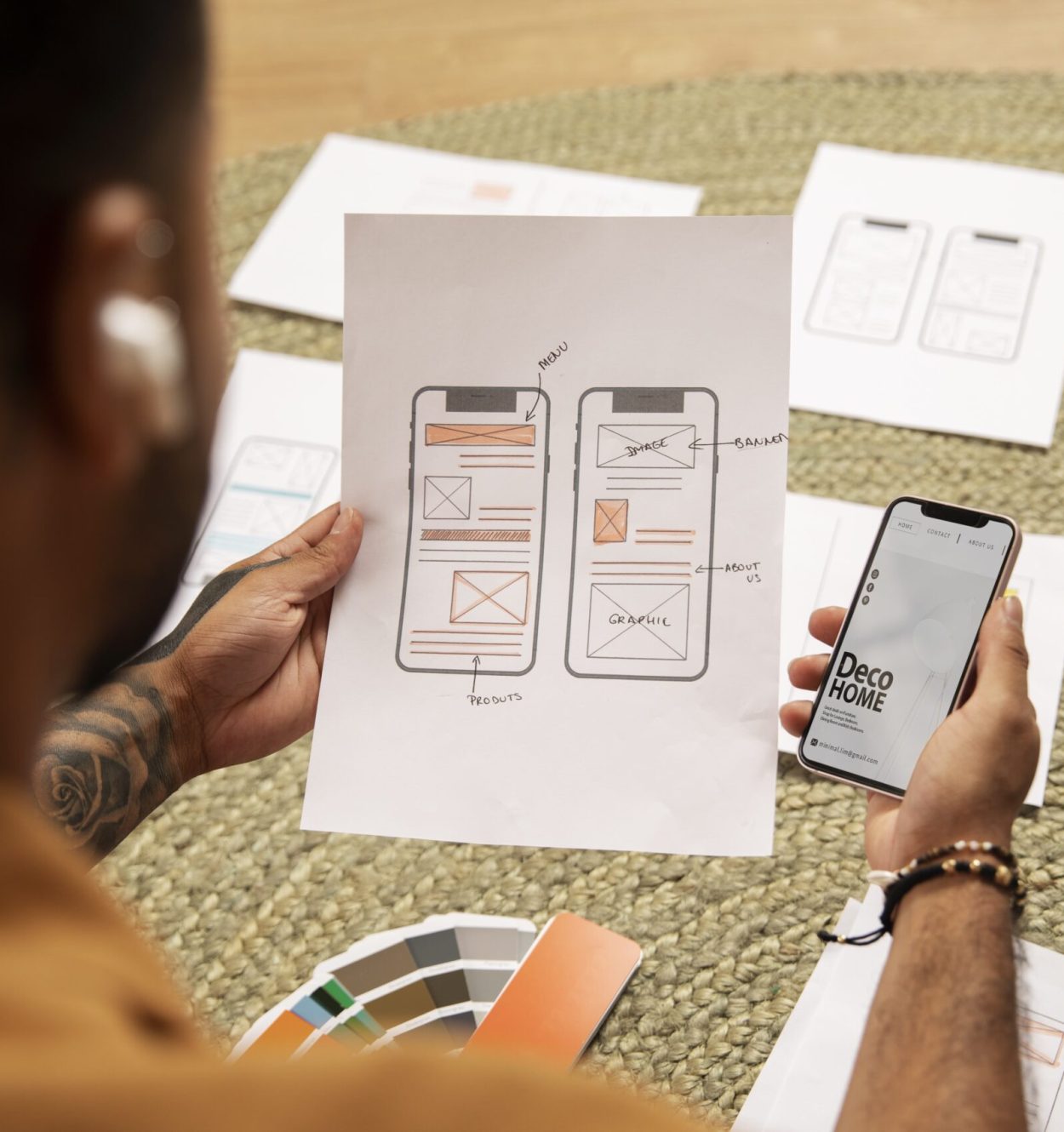 High angle designer holding smartphone min