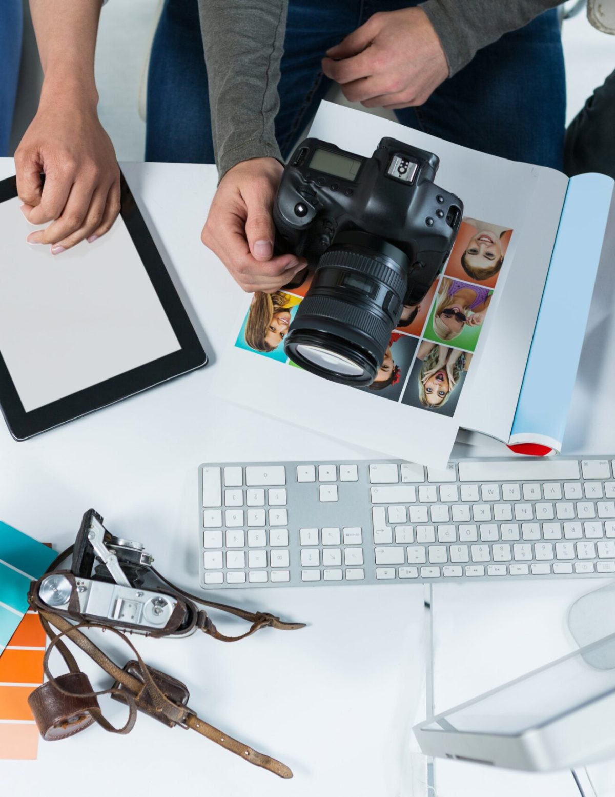 Team photographers working computer desk min