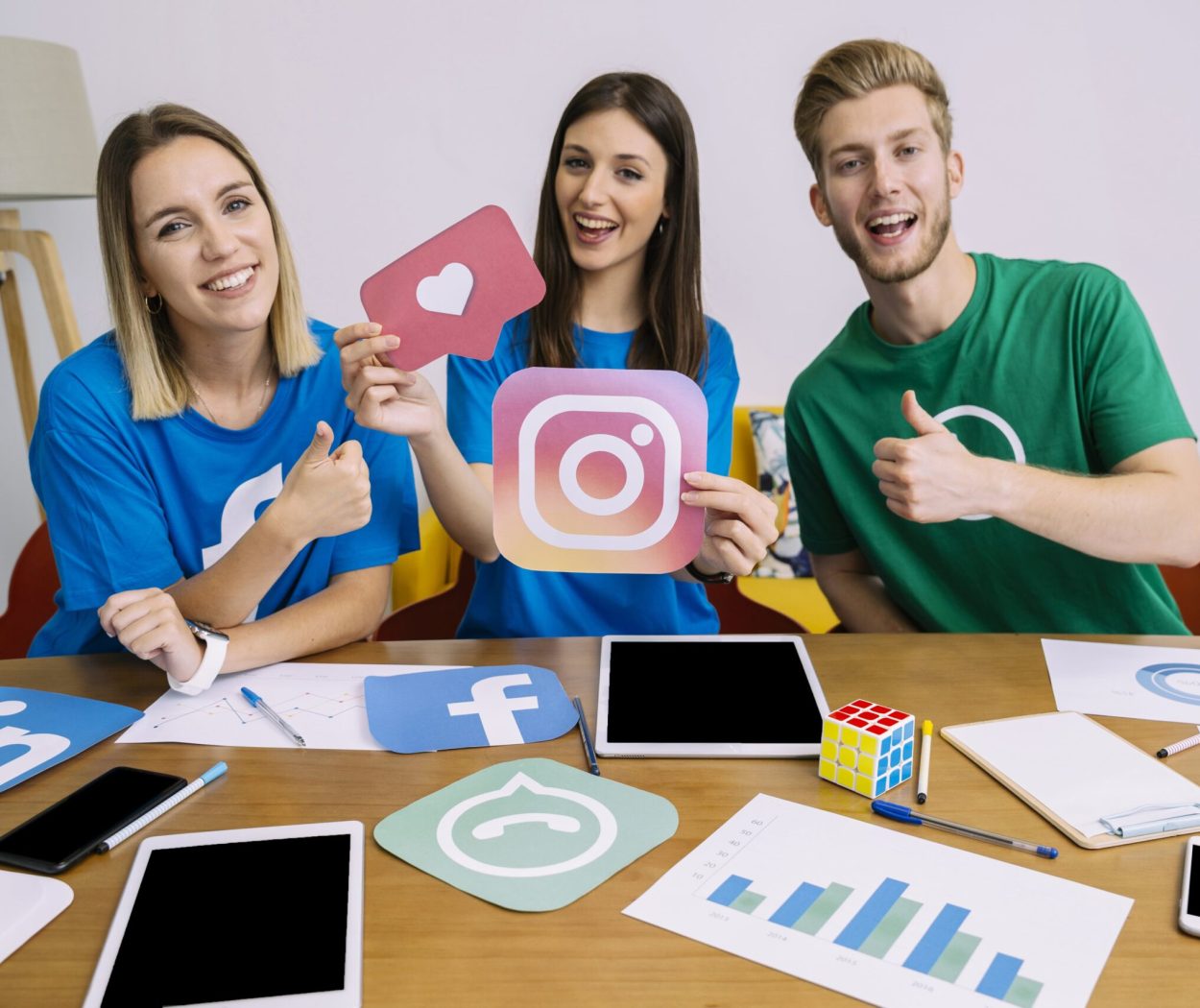 Woman holding snapchat logo with his friends showing thumbup sign min